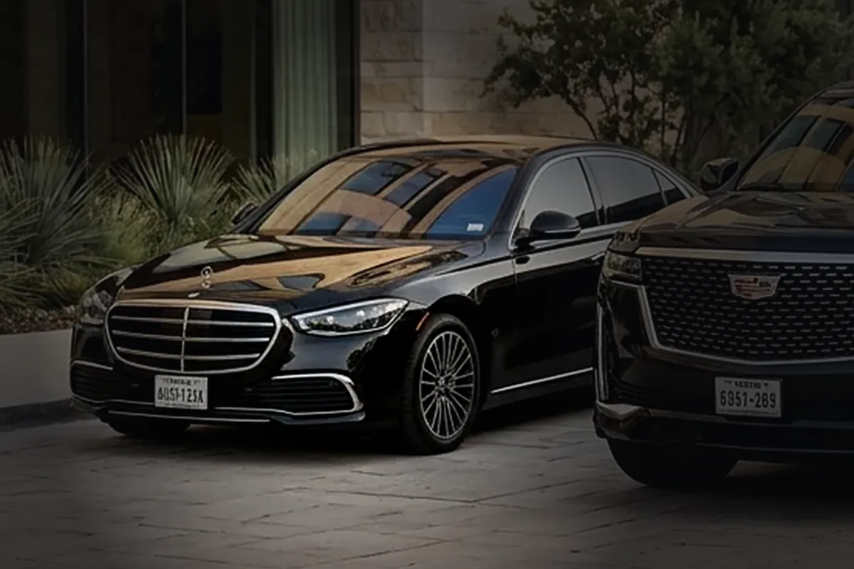 Executive black sedan, front three-quarter view